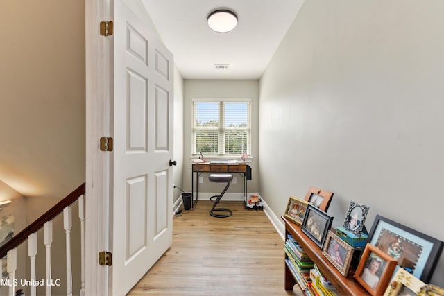 12441 Old Cypress Creek Cv, Diberville, MS 39540 - hallway with light wood-style flooring and a desk