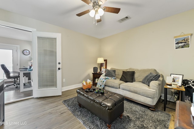 12441 Old Cypress Creek Cv, Diberville, MS 39540 - living room featuring a desk, ceiling fan, and wood finished floors