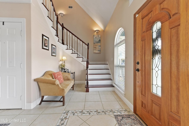 12441 Old Cypress Creek Cv, Diberville, MS 39540 - entrance foyer featuring light tile patterned floors, stairway, and vaulted ceiling