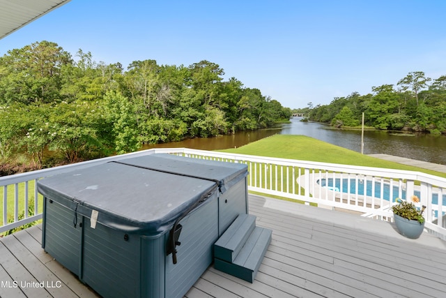 12441 Old Cypress Creek Cv, Diberville, MS 39540 - wooden deck featuring a hot tub, a water view, a yard, and view of wooded area