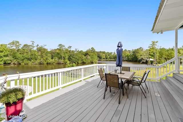 12441 Old Cypress Creek Cv, Diberville, MS 39540 - deck with a water view, a yard, outdoor dining area, and view of wooded area