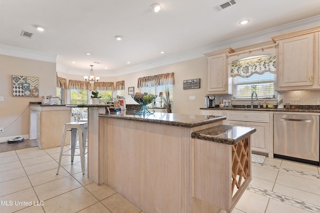 12441 Old Cypress Creek Cv, Diberville, MS 39540 - kitchen with stainless steel dishwasher, light brown cabinets, light tile patterned floors, healthy amount of natural light, and crown molding
