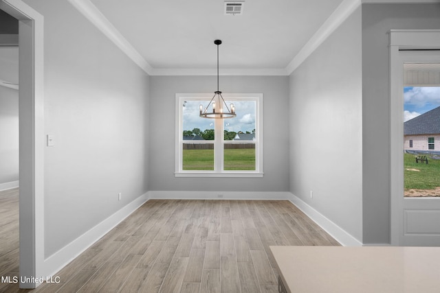 unfurnished dining area with light hardwood / wood-style floors, a notable chandelier, a healthy amount of sunlight, and crown molding