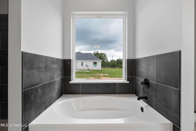 bathroom featuring a washtub and a wealth of natural light