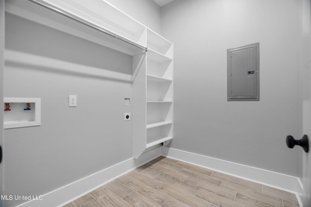 washroom with electric panel, light hardwood / wood-style flooring, electric dryer hookup, and washer hookup