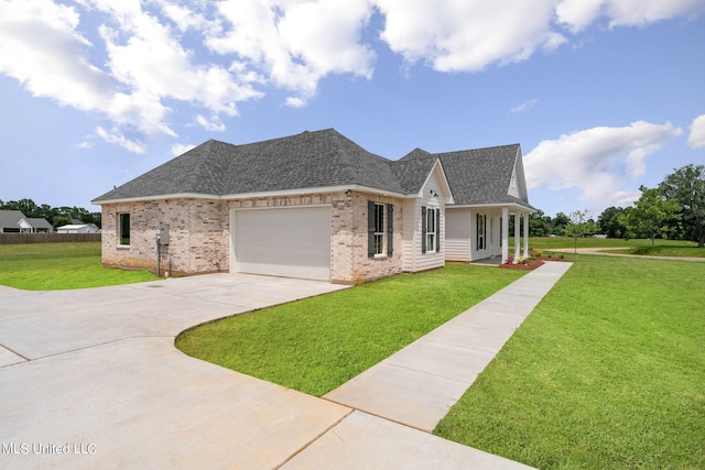 view of front of property with a front yard and a garage