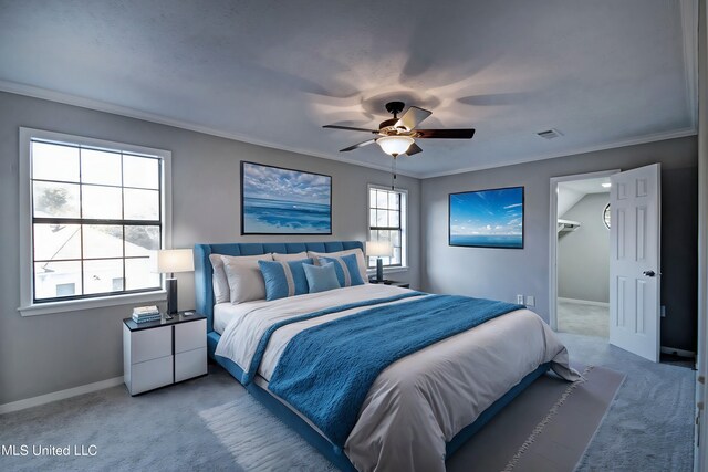 bedroom featuring ceiling fan, ornamental molding, and carpet floors