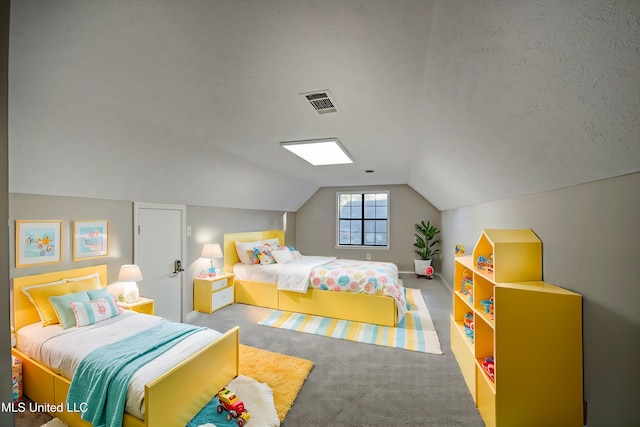 carpeted bedroom with a textured ceiling and vaulted ceiling