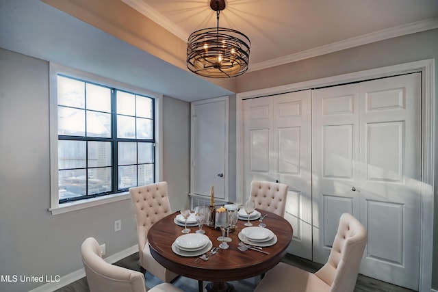 dining space featuring a notable chandelier, ornamental molding, plenty of natural light, and dark hardwood / wood-style flooring