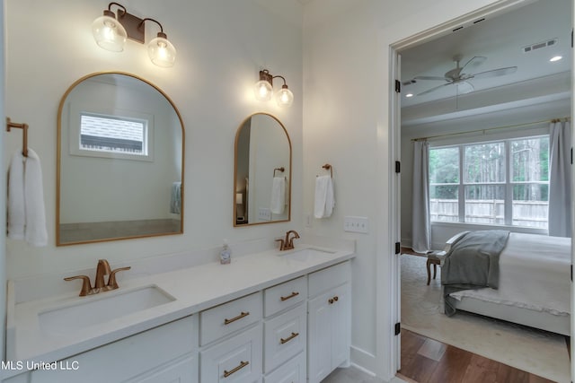 bathroom featuring hardwood / wood-style flooring, ceiling fan, and vanity