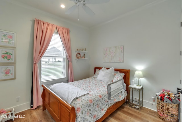 bedroom with light hardwood / wood-style flooring and ceiling fan