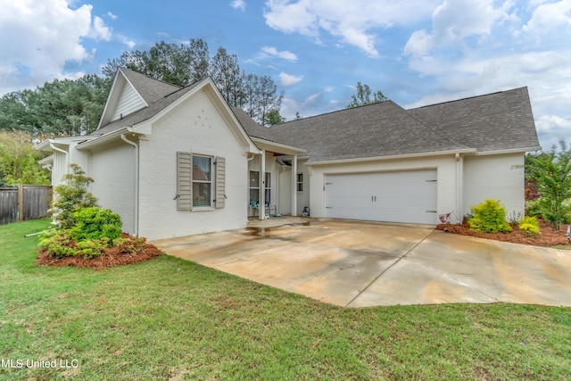 view of front of property with a front yard and a garage