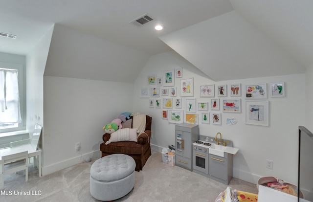 rec room featuring vaulted ceiling and light colored carpet