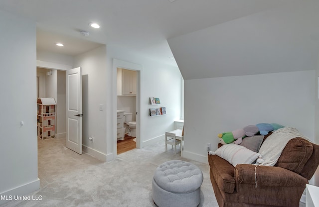 sitting room featuring light carpet