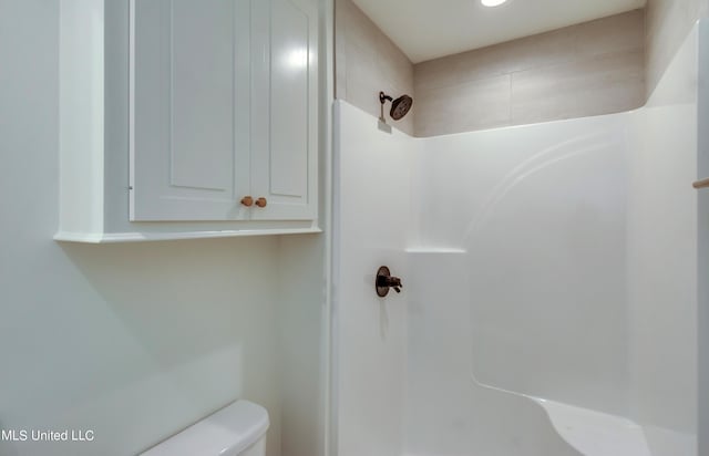 bathroom with toilet and a shower