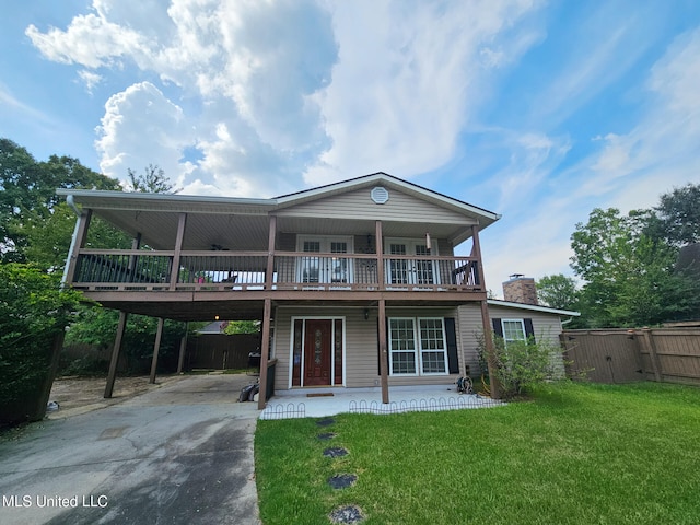 906 W Lakeshore Dr, Carriere, MS 39426 - view of front facade with driveway, a wooden deck, a chimney, and a carport