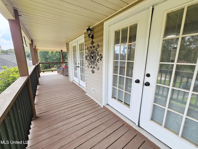 906 W Lakeshore Dr, Carriere, MS 39426 - wooden deck featuring french doors and covered porch