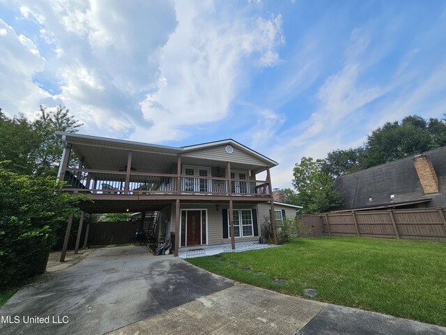 906 W Lakeshore Dr, Carriere, MS 39426 - rear view of property featuring driveway, a carport, and a deck