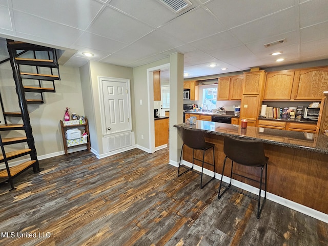 906 W Lakeshore Dr, Carriere, MS 39426 - kitchen with dishwasher, dark wood-style floors, baseboards, a breakfast bar, and a paneled ceiling