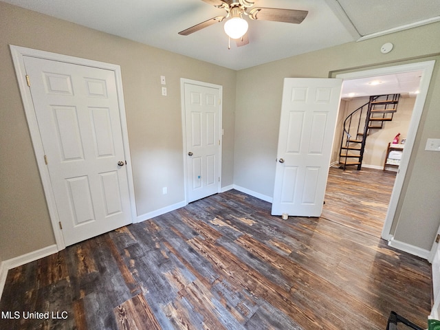 906 W Lakeshore Dr, Carriere, MS 39426 - unfurnished bedroom with dark wood finished floors, baseboards, and a ceiling fan