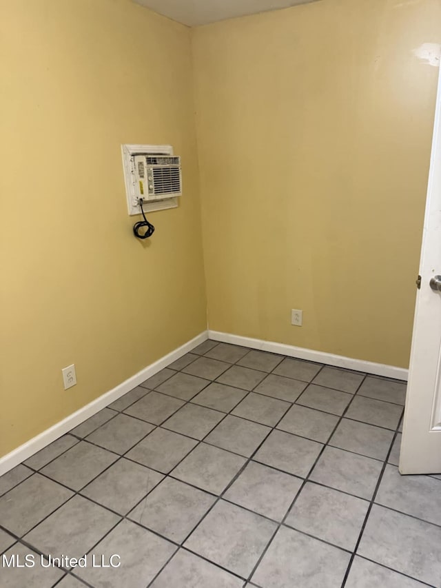 324 Crawford St, Biloxi, MS 39530 - empty room featuring a wall unit AC, baseboards, and light tile patterned flooring
