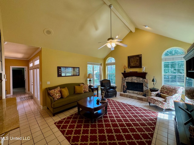 tiled living room featuring ceiling fan, a stone fireplace, high vaulted ceiling, and beam ceiling