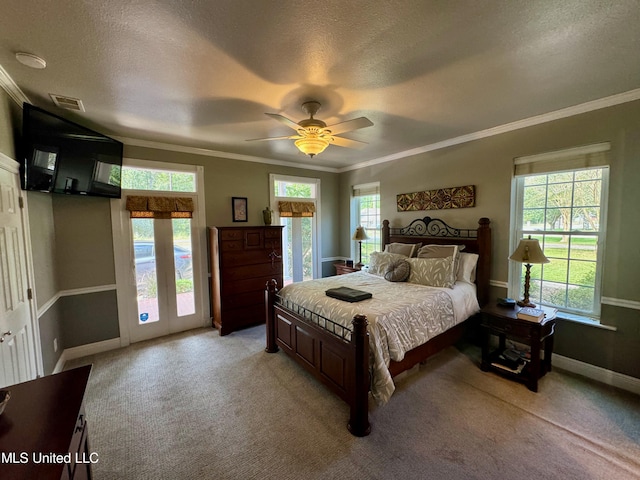 carpeted bedroom featuring ceiling fan, crown molding, and a textured ceiling