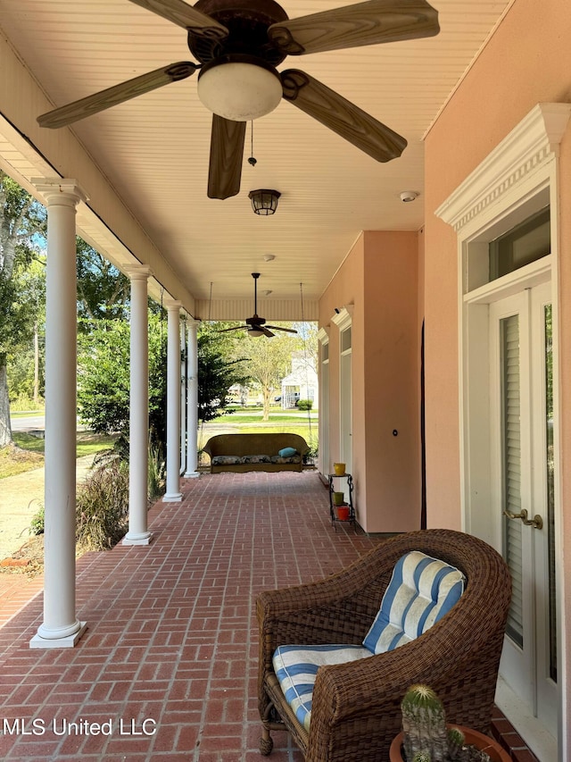 view of patio featuring ceiling fan and a porch