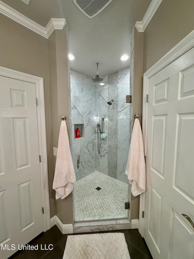 bathroom with tile patterned floors, walk in shower, and ornamental molding