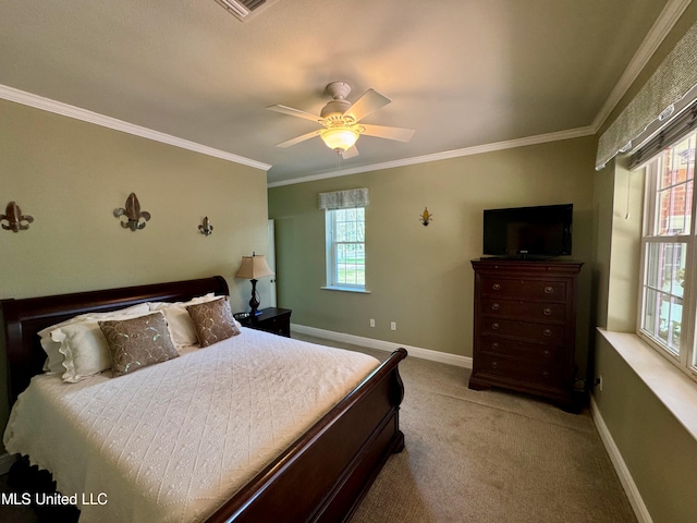 carpeted bedroom with ornamental molding and ceiling fan