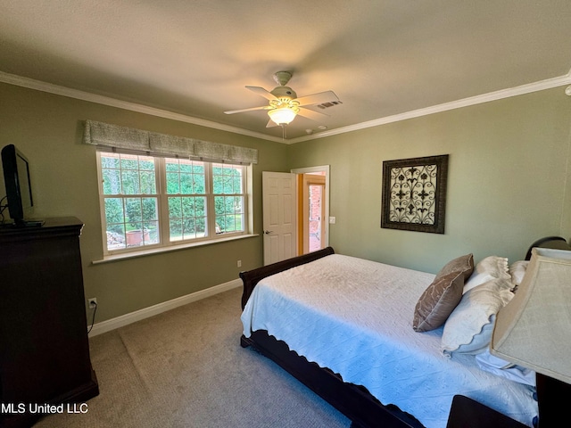 carpeted bedroom with ornamental molding and ceiling fan