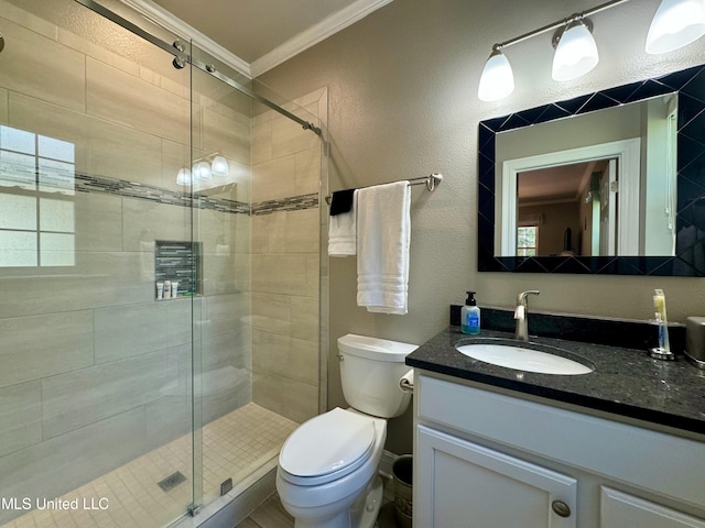 bathroom with vanity, toilet, ornamental molding, and an enclosed shower