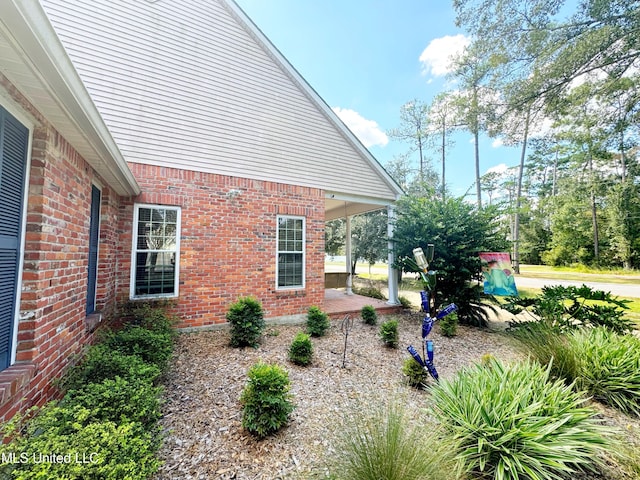 view of side of property with a patio area