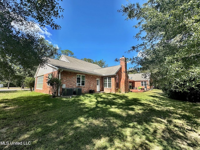 back of property featuring a lawn