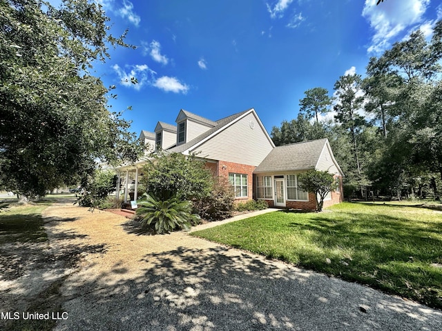 view of side of property with a lawn