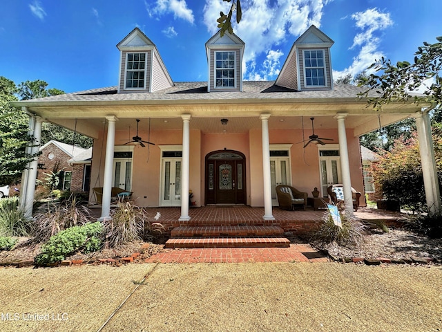 doorway to property featuring a porch, french doors, and ceiling fan