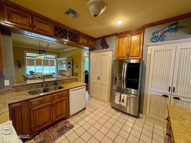 kitchen featuring sink, white dishwasher, hanging light fixtures, ornamental molding, and stainless steel refrigerator with ice dispenser