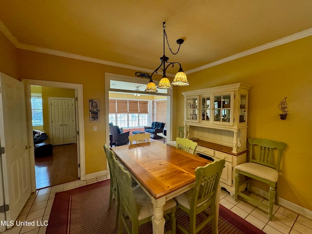 tiled dining space featuring crown molding