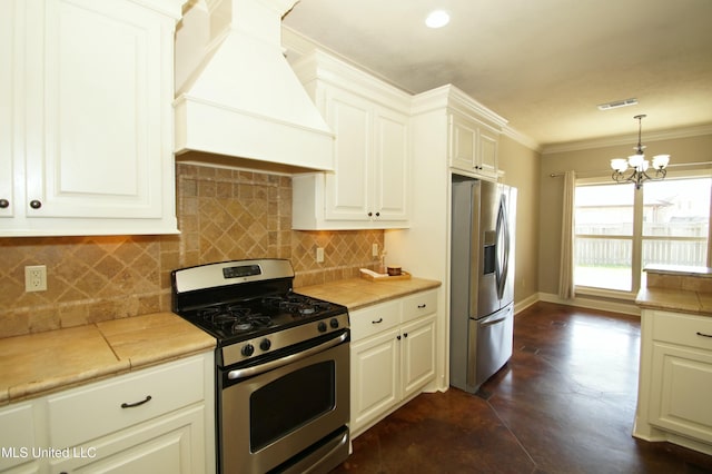 kitchen featuring backsplash, ornamental molding, appliances with stainless steel finishes, an inviting chandelier, and custom exhaust hood