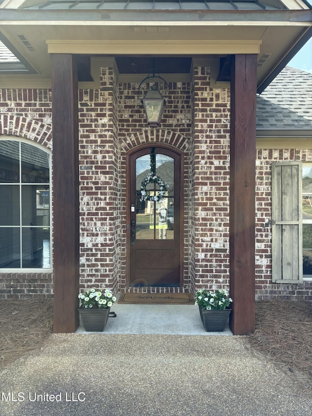 entrance to property with brick siding