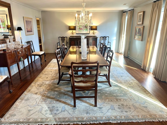 dining area with wood-type flooring, a wealth of natural light, an inviting chandelier, and ornamental molding