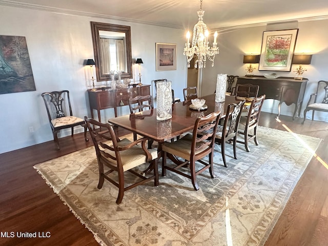 dining area featuring hardwood / wood-style flooring, ornamental molding, and a chandelier