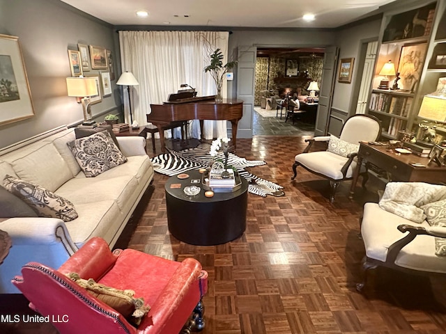 living room with ornamental molding and dark parquet floors