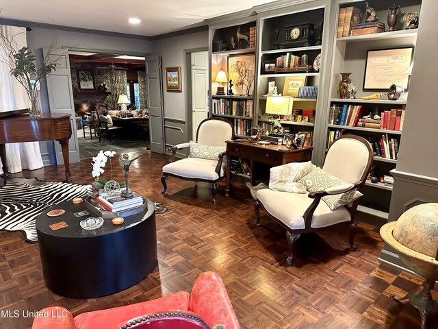 living area with dark parquet flooring and crown molding