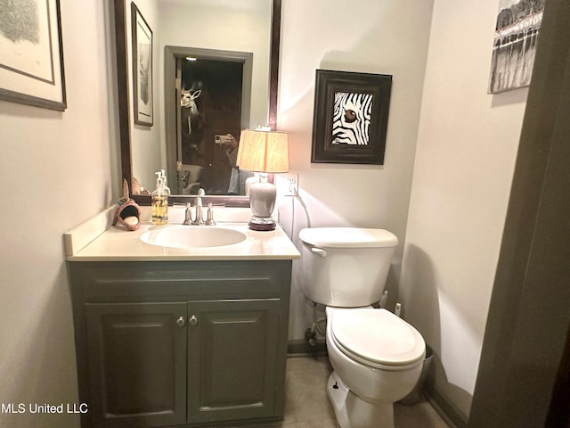 bathroom featuring toilet and vanity