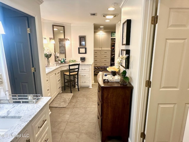 bathroom featuring ornamental molding, tile patterned flooring, and sink