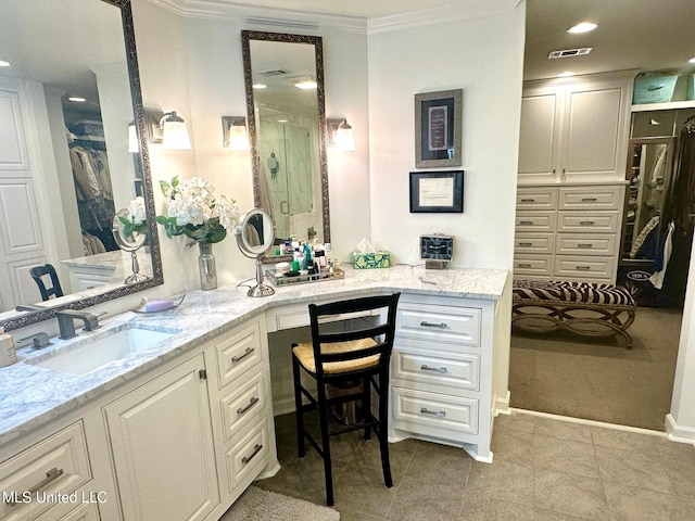 bathroom with tile patterned floors, vanity, ornamental molding, and an enclosed shower