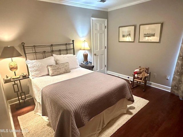 bedroom featuring dark wood-type flooring and crown molding