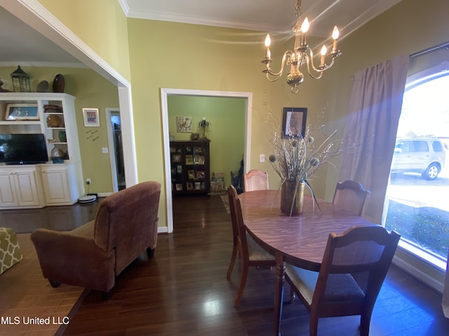 dining area with dark wood-type flooring, a chandelier, and ornamental molding