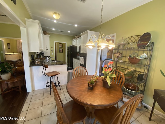 dining room with light tile patterned floors, baseboards, an inviting chandelier, recessed lighting, and ornamental molding